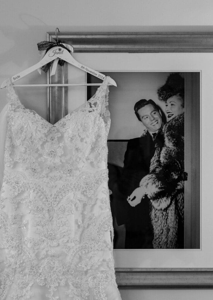 Wedding dress hanging on a famous photograph from the 50's as the bride gets ready in Edinburgh