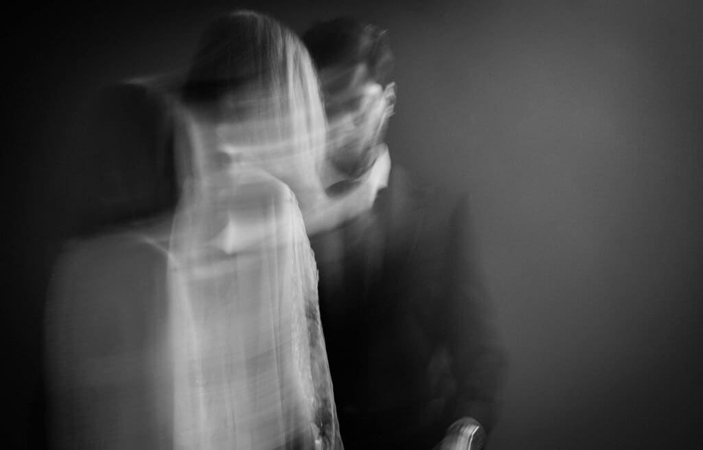 Bride and groom walk toward each other in moody image 