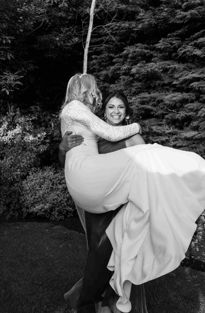 Bride having fun with her maid of honour at the reception in Scotland