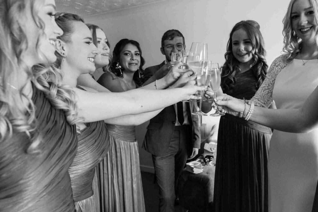 The bridal party toast the bride with champagne