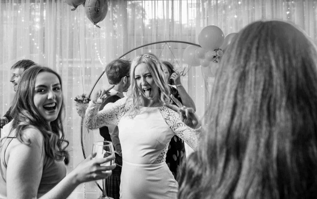 The bride dances with friends